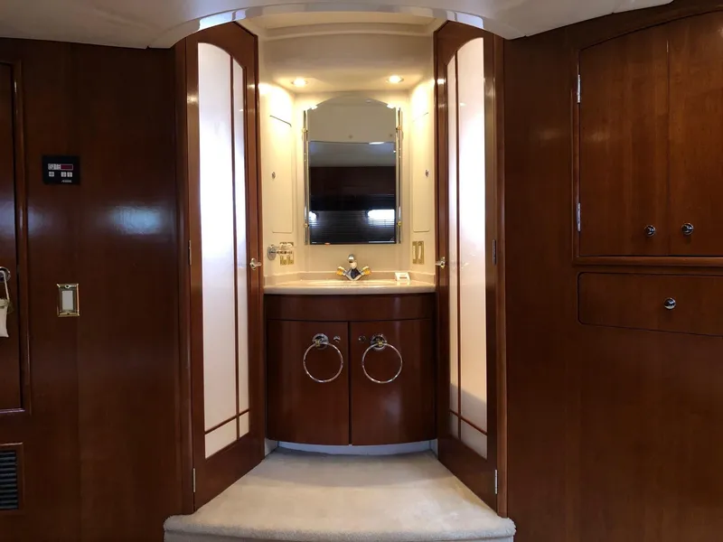 Slide: The Image of 1998 Carver 530 Voyager Pilothouse bathroom with wooden cabinetry and mirror. - 38
