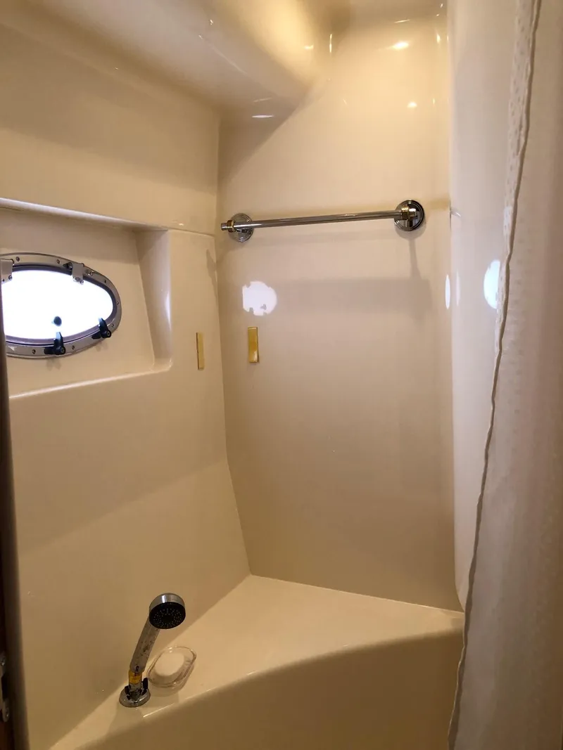 Slide: The Image of 1998 Carver 530 Voyager Pilothouse bathroom with shower and porthole window. - 40