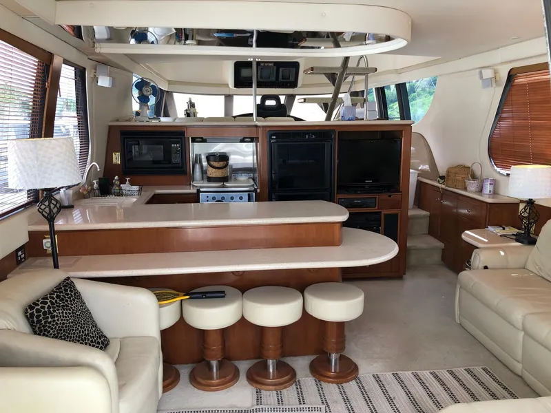 Slide: The Image of Interior of 1998 Carver 530 Voyager Pilothouse yacht with modern kitchen and seating area. - 7