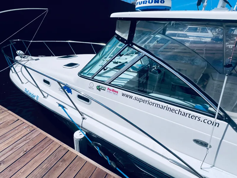 Slide: The Image of 2002 Pursuit 3000 Express boat docked, featuring Superior Marine Charters branding. - 5
