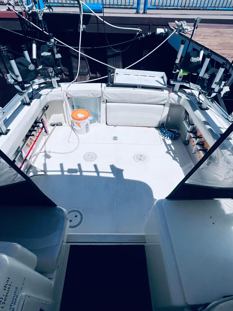 Slide: The Image of 2002 Pursuit 3000 Express boat interior with fishing gear and equipment. - 6