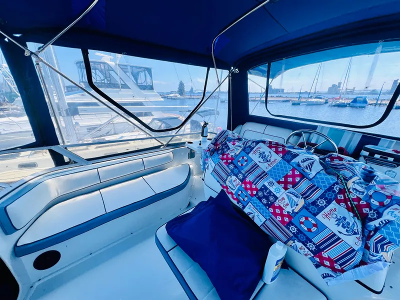 Slide: The Image of Interior of a 2002 Pursuit 3000 Express boat with nautical-themed decor. - 8