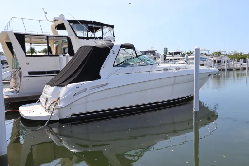Slide: The Image of 1999 Sea Ray 380 Sundancer yacht docked in a marina. - 0