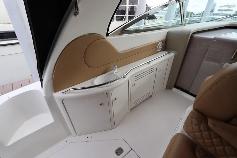 Slide: The Image of 1999 Sea Ray 380 Sundancer interior with sink and storage cabinets. - 13