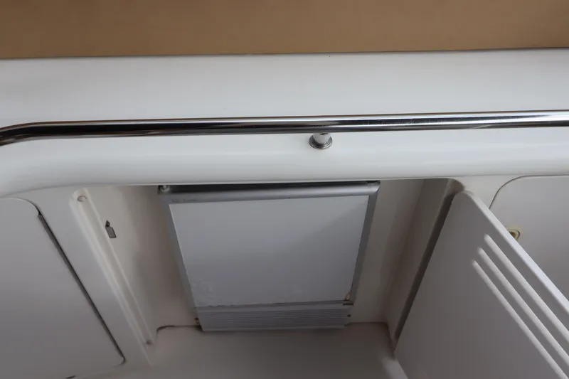 Slide: The Image of 1999 Sea Ray 380 Sundancer interior detail with white cabinetry and stainless steel accents. - 14