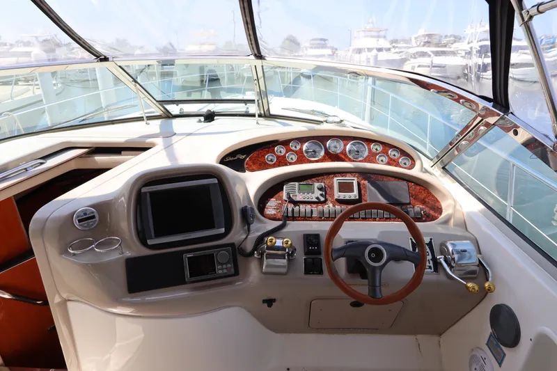 Slide: The Image of Helm of 1999 Sea Ray 380 Sundancer with navigation instruments and wooden steering wheel. - 19