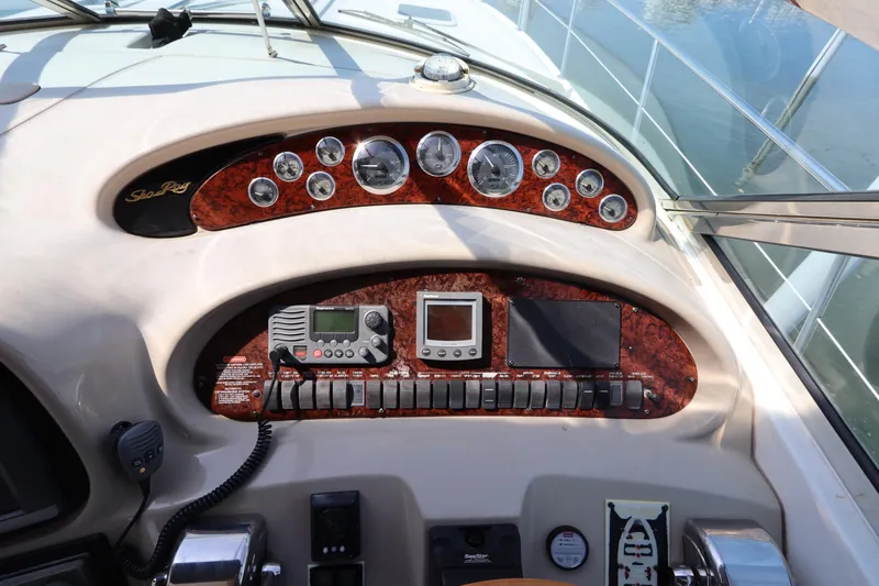 Slide: The Image of Control panel of a 1999 Sea Ray 380 Sundancer boat with gauges and navigation equipment. - 21