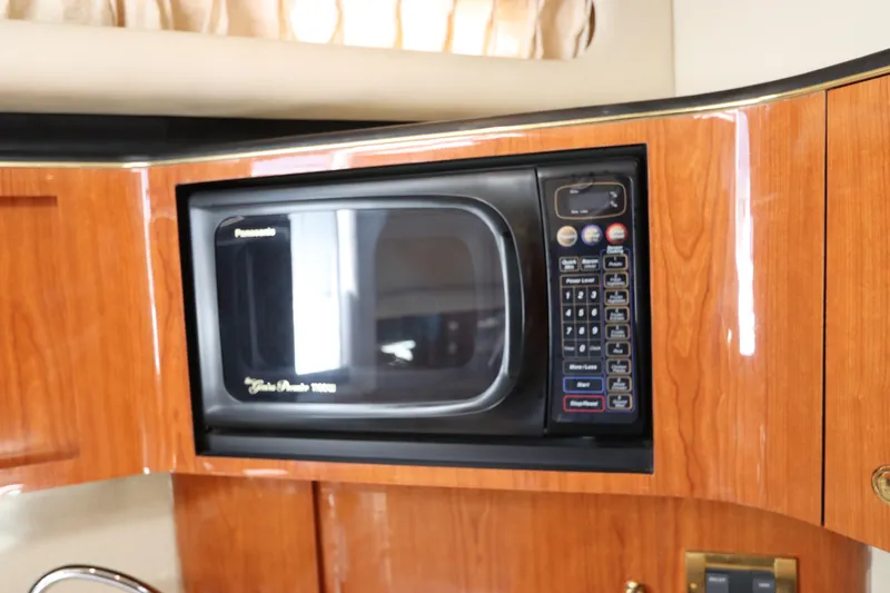 Slide: The Image of Built-in microwave in the 1999 Sea Ray 380 Sundancer yacht's wooden interior. - 28