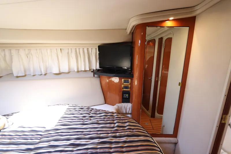 Slide: The Image of Interior cabin of 1999 Sea Ray 380 Sundancer with bed, TV, and mirror. - 32