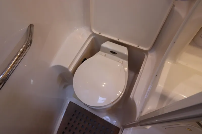 Slide: The Image of 1999 Sea Ray 380 Sundancer bathroom with toilet and handrail. - 36