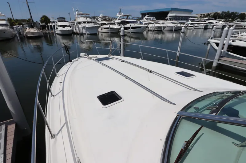 Slide: The Image of 1999 Sea Ray 380 Sundancer docked at a marina with other boats. - 4
