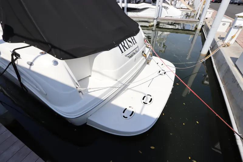 Slide: The Image of 1999 Sea Ray 380 Sundancer docked, rear view with black cover. - 7