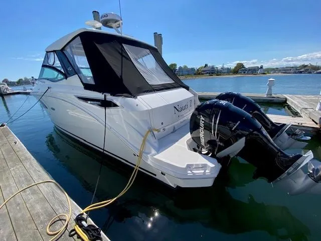 Slide: The Image of 2022 Sea Ray 320 Sundancer Outboard docked, featuring twin Mercury engines. - 3