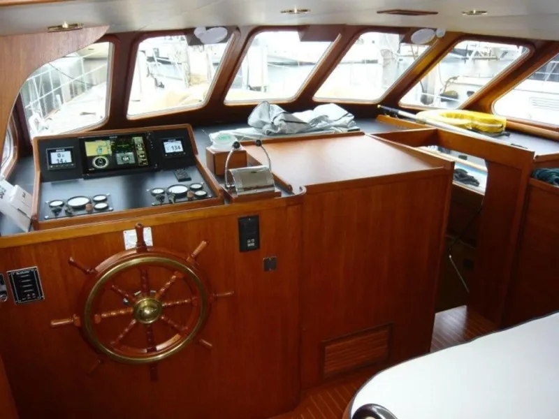 Slide: The Image of Interior of 1990 Cheoy Lee Sloop with wooden helm and navigation instruments. - 25