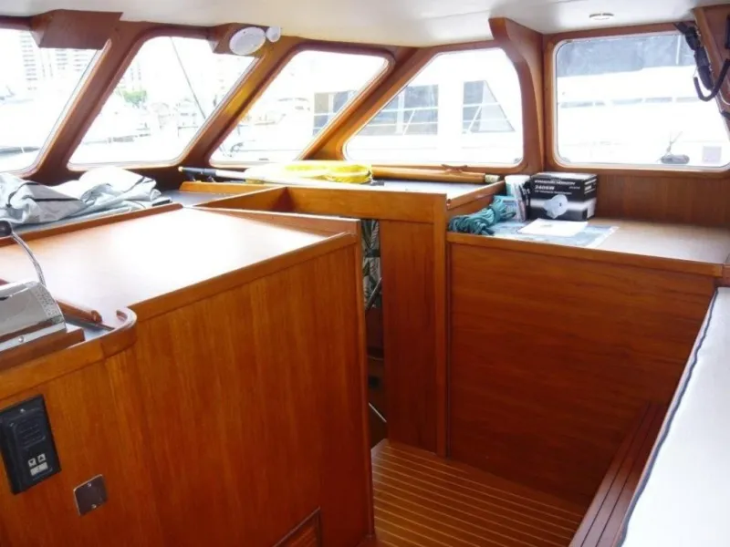 Slide: The Image of Interior of 1990 Cheoy Lee Sloop with wooden cabinetry and large windows. - 27