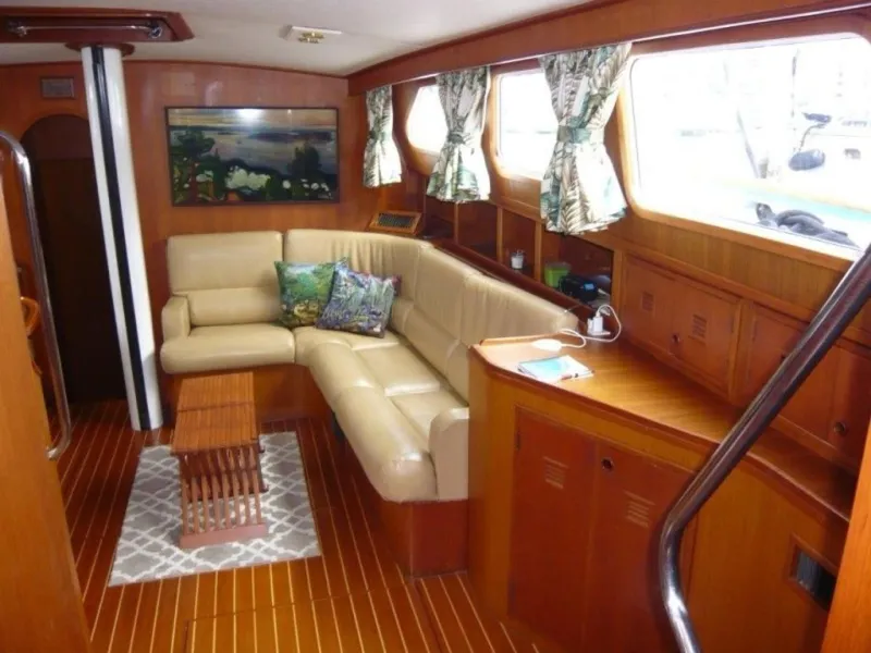Slide: The Image of Interior of 1990 Cheoy Lee Sloop with cozy seating and wooden decor. - 32