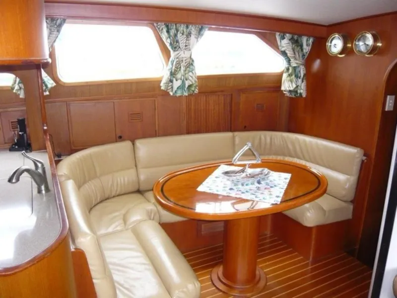 Slide: The Image of Luxurious 1990 Cheoy Lee Sloop interior with leather seating and wooden dining table. - 36
