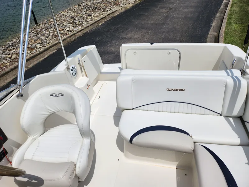 Slide: The Image of 2008 Glastron GT 249 boat interior with white seating and steering chair. - 15