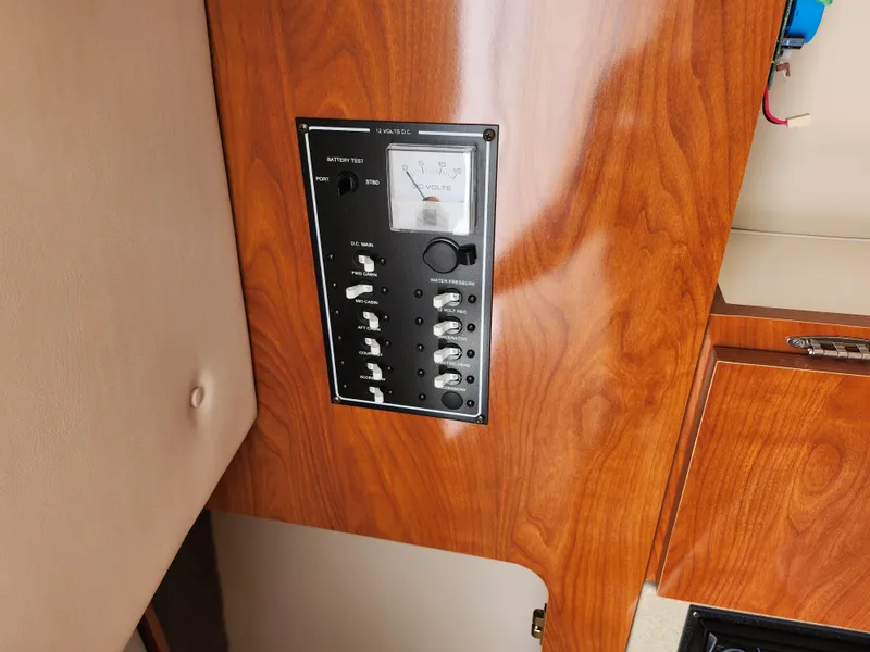 Slide: The Image of 2008 Glastron GT 249 control panel with wood finish. - 24