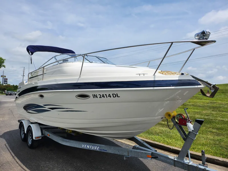 Slide: The Image of 2008 Glastron GT 249 boat on a trailer, parked outdoors. - 5