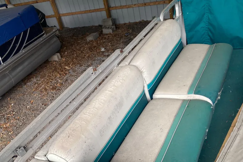 Slide: The Image of 1994 Sun Tracker PARTY HUT 30 OB pontoon boat interior with worn seating. - 4