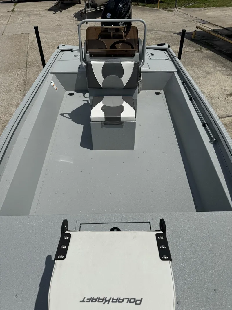 Slide: The Image of 2023 Polar Kraft SPORTX210CC boat interior with center console and seating. - 10