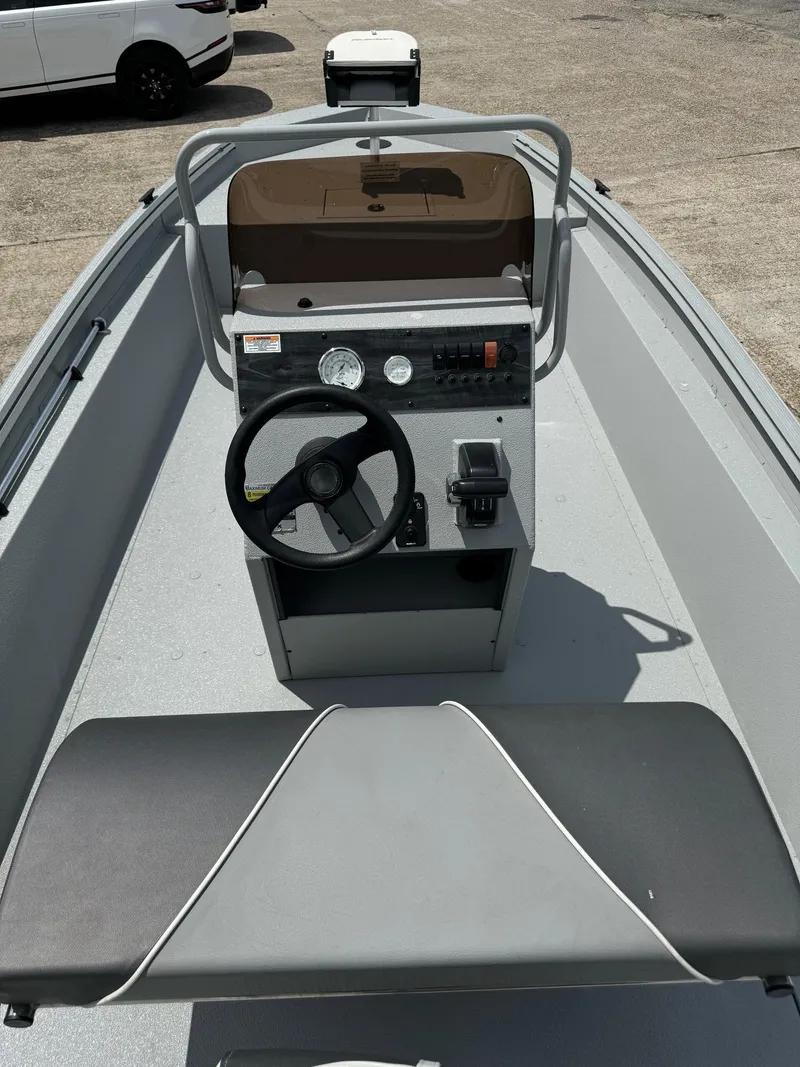 Slide: The Image of 2023 Polar Kraft SPORTX210CC boat interior with steering console and seating. - 9