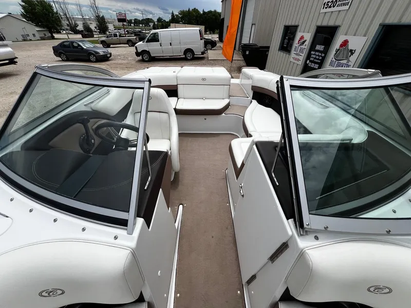 Slide: The Image of 2011 Cobalt 200 boat interior with white seating and steering wheel. - 10