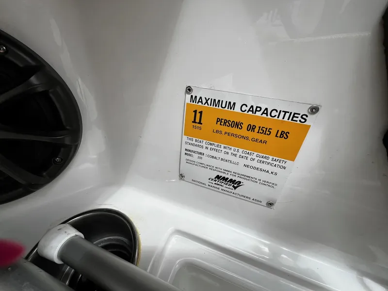 Slide: The Image of 2011 Cobalt 200 boat capacity label, 11 persons or 1515 lbs, U.S. Coast Guard compliant. - 13