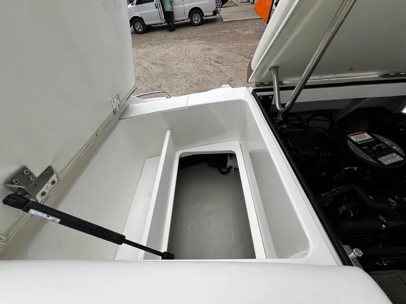 Slide: The Image of Open engine compartment of a 2011 Cobalt 200 boat with storage space. - 16