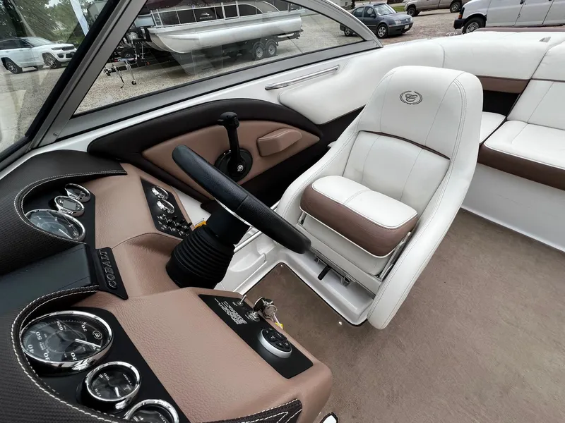 Slide: The Image of Interior of a 2011 Cobalt 200 boat with steering wheel and dashboard. - 18