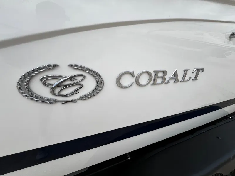 Slide: The Image of 2011 Cobalt 200 boat emblem and logo on white surface. - 2