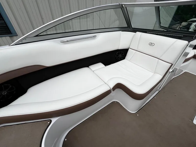 Slide: The Image of 2011 Cobalt 200 boat interior with white and brown seating. - 21