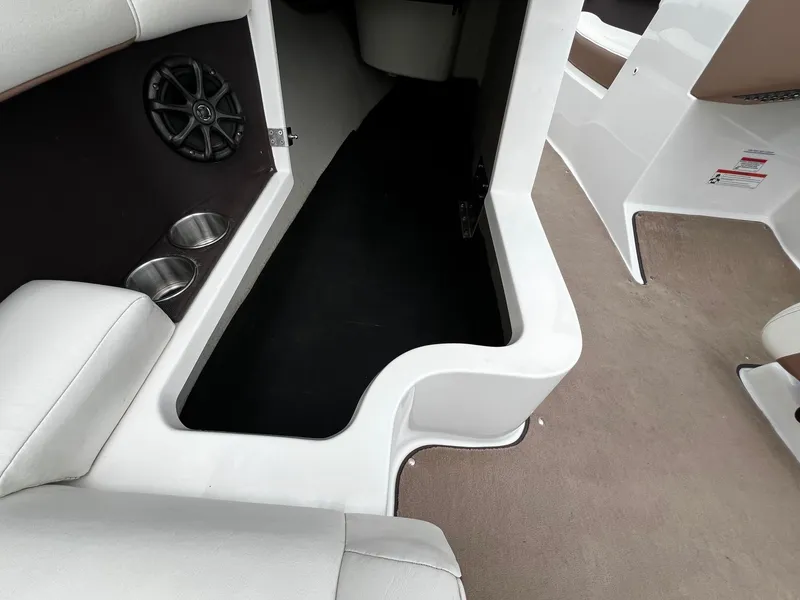 Slide: The Image of Interior of a 2011 Cobalt 200 boat with cup holders and speaker. - 22