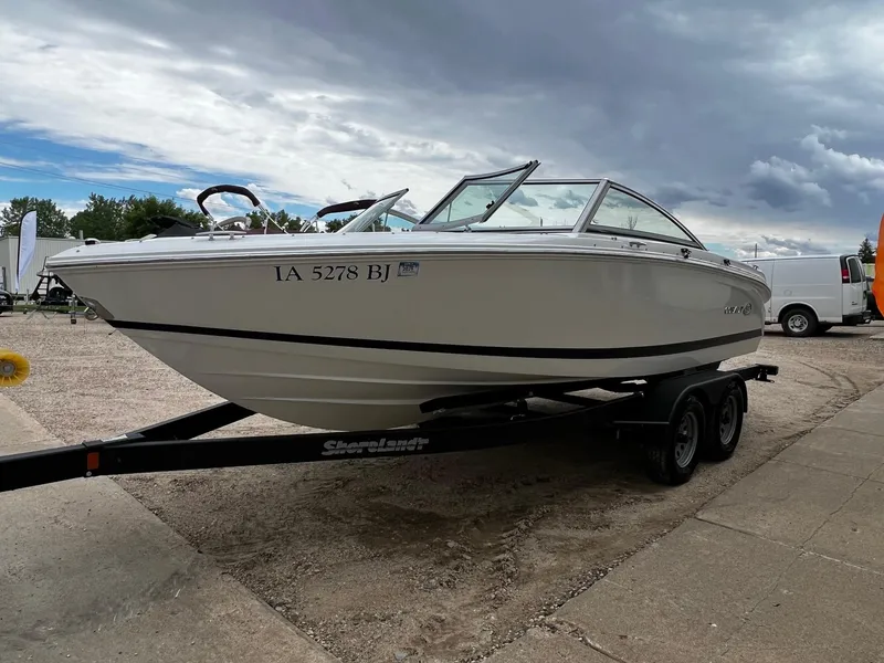 Slide: The Image of 2011 Cobalt 200 boat on trailer, parked outdoors under cloudy sky. - 5