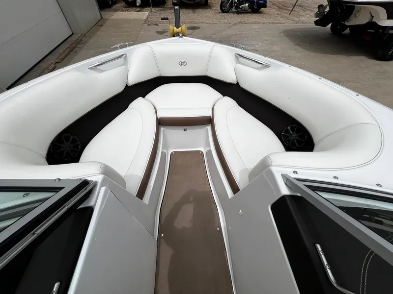 Slide: The Image of 2011 Cobalt 200 boat with white cushioned seating and brown accents. - 9
