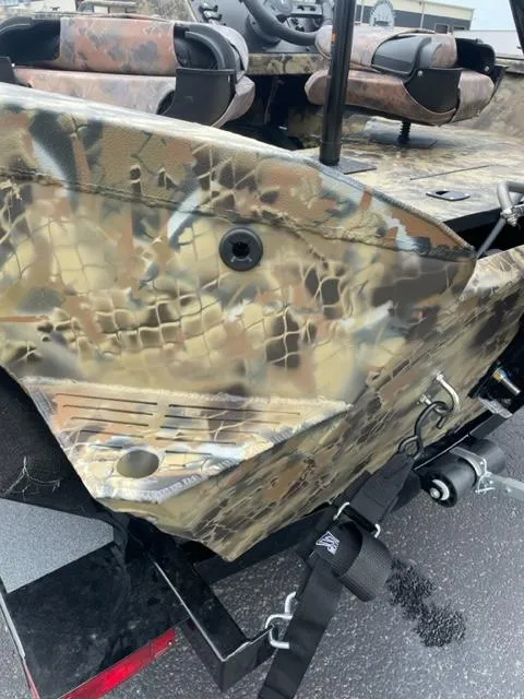 Slide: The Image of 2024 Excel 1751 River Warrior boat with camouflage pattern on a trailer. - 10