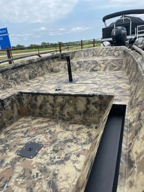 Slide: The Image of 2024 Excel 1751 River Warrior boat with camouflage design on a trailer. - 6