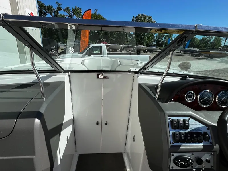 Slide: The Image of 2004 Regal 2200 Bowrider dashboard and cockpit view with open windshield. - 11