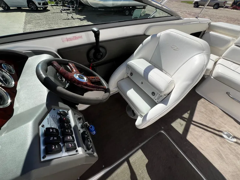 Slide: The Image of 2004 Regal 2200 Bowrider boat interior with steering wheel and captain's seat. - 14