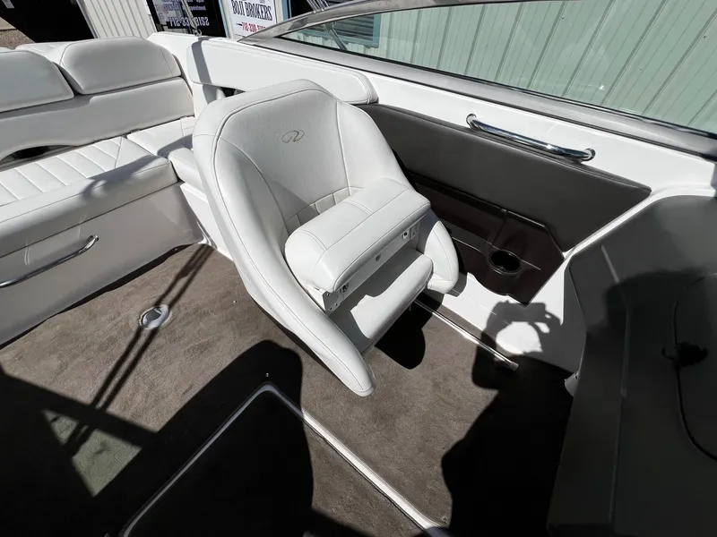 Slide: The Image of Interior of a 2004 Regal 2200 Bowrider boat with white seating and carpeted floor. - 15