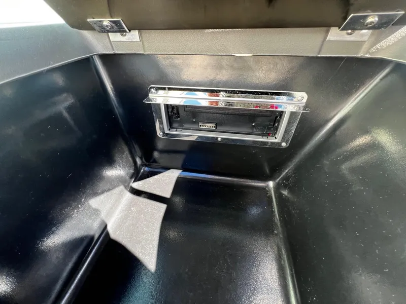 Slide: The Image of 2004 Regal 2200 Bowrider storage compartment with built-in stereo system. - 16