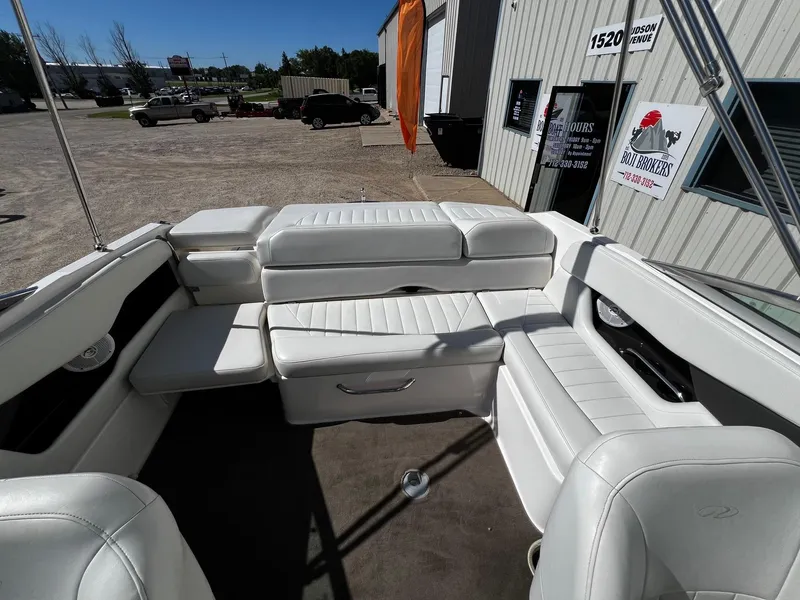 Slide: The Image of 2004 Regal 2200 Bowrider interior with white leather seating, parked outside dealership. - 17