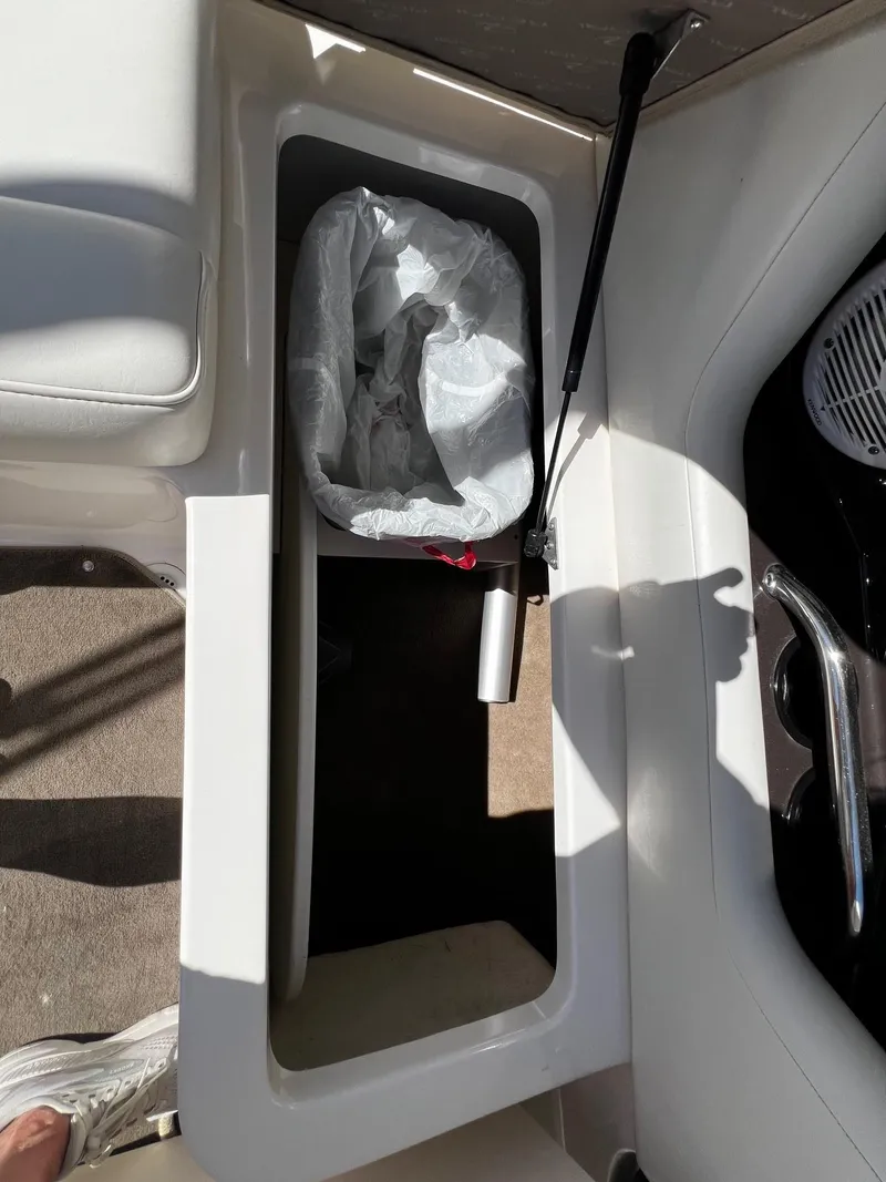 Slide: The Image of Trash bin compartment in a 2004 Regal 2200 Bowrider boat. - 22