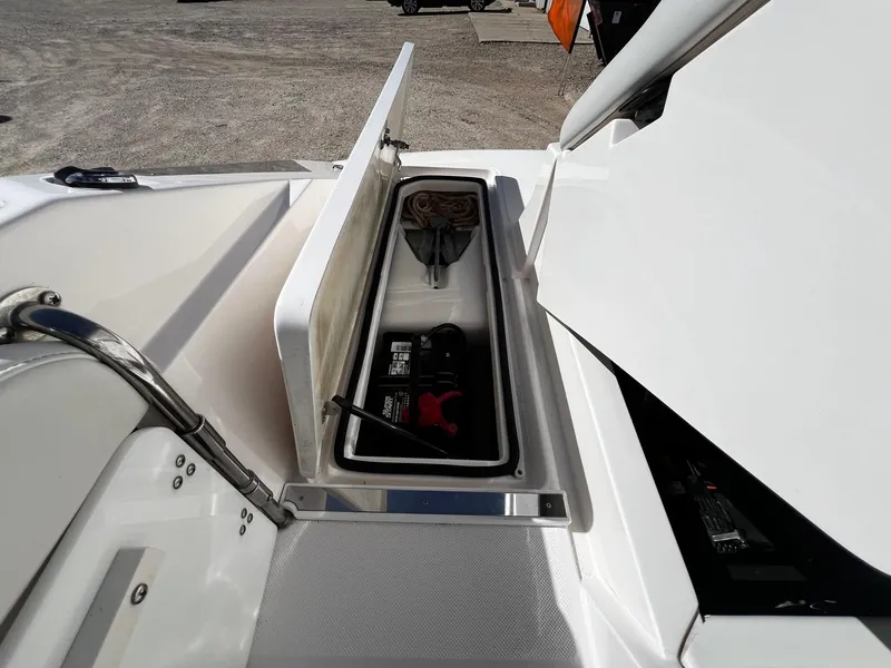 Slide: The Image of Open storage compartment on a 2004 Regal 2200 Bowrider boat. - 24