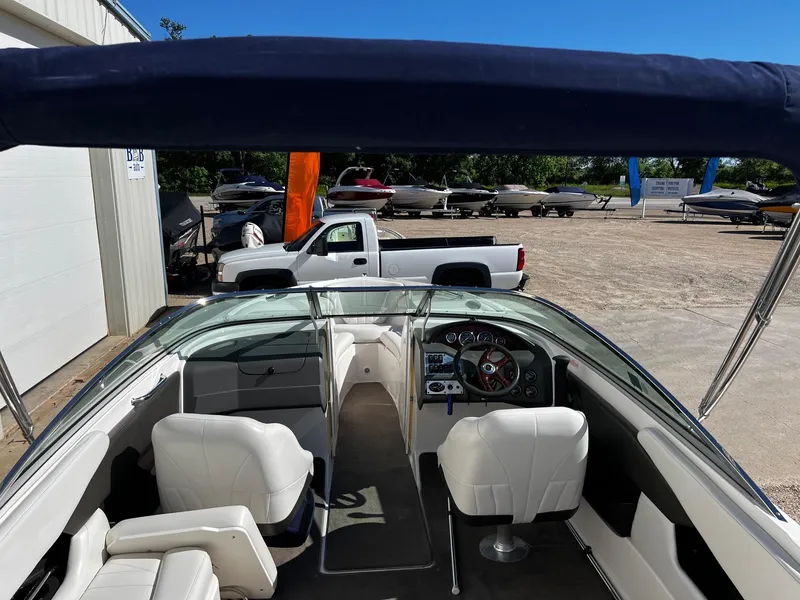 Slide: The Image of 2004 Regal 2200 Bowrider boat interior with white seats and dashboard. - 6