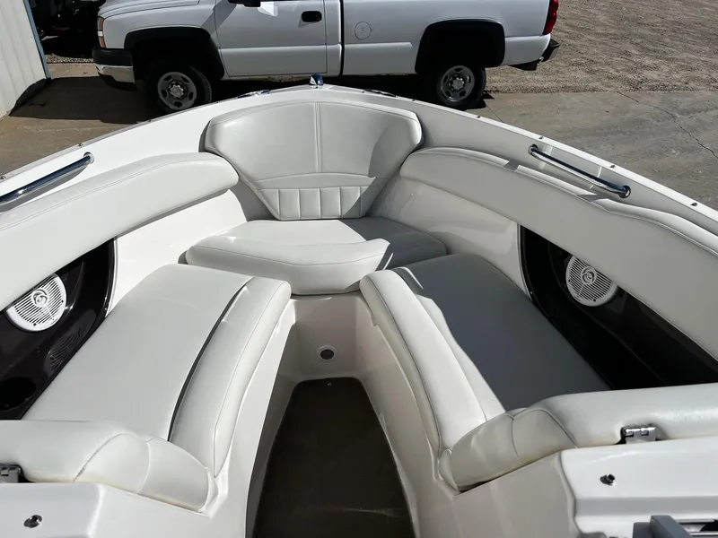 Slide: The Image of 2004 Regal 2200 Bowrider boat interior with white leather seating. - 7