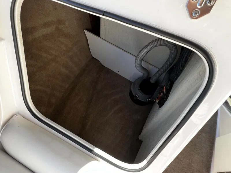 Slide: The Image of Storage compartment of a 2004 Regal 2200 Bowrider boat with carpeted interior. - 9