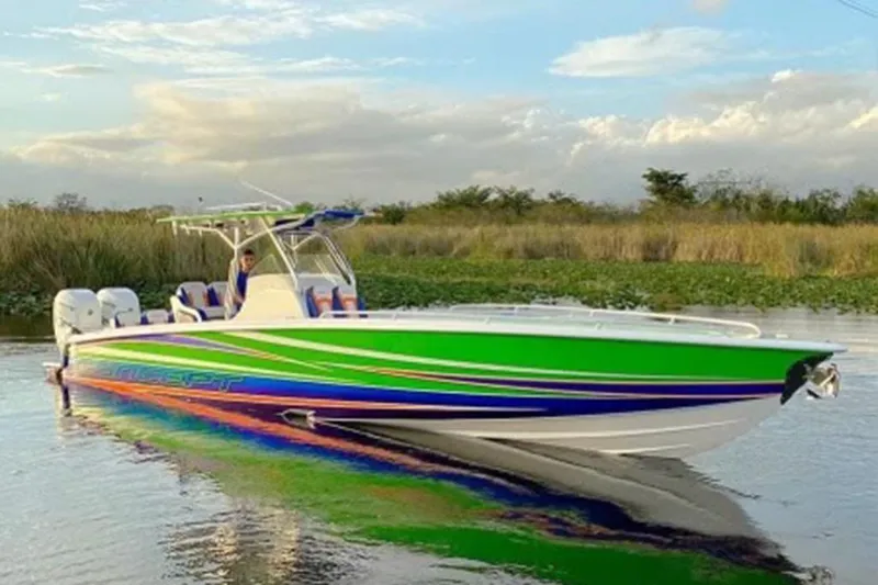 The Image of 2020 Concept 36' Cuddy Cabin boat with vibrant green and blue design on calm water. - 0