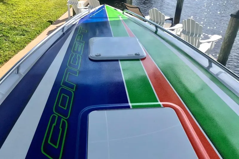 Slide: The Image of 2020 Concept 36' Cuddy Cabin boat with colorful deck design docked by the water. - 3